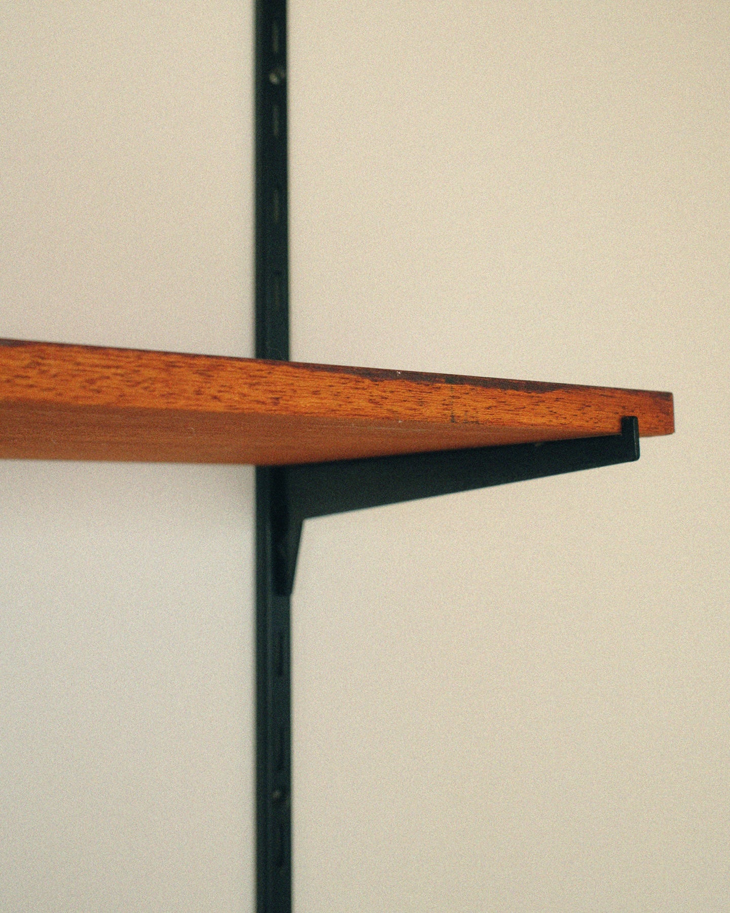 Modular wall unit, teak veneer shelves and black metal uprights