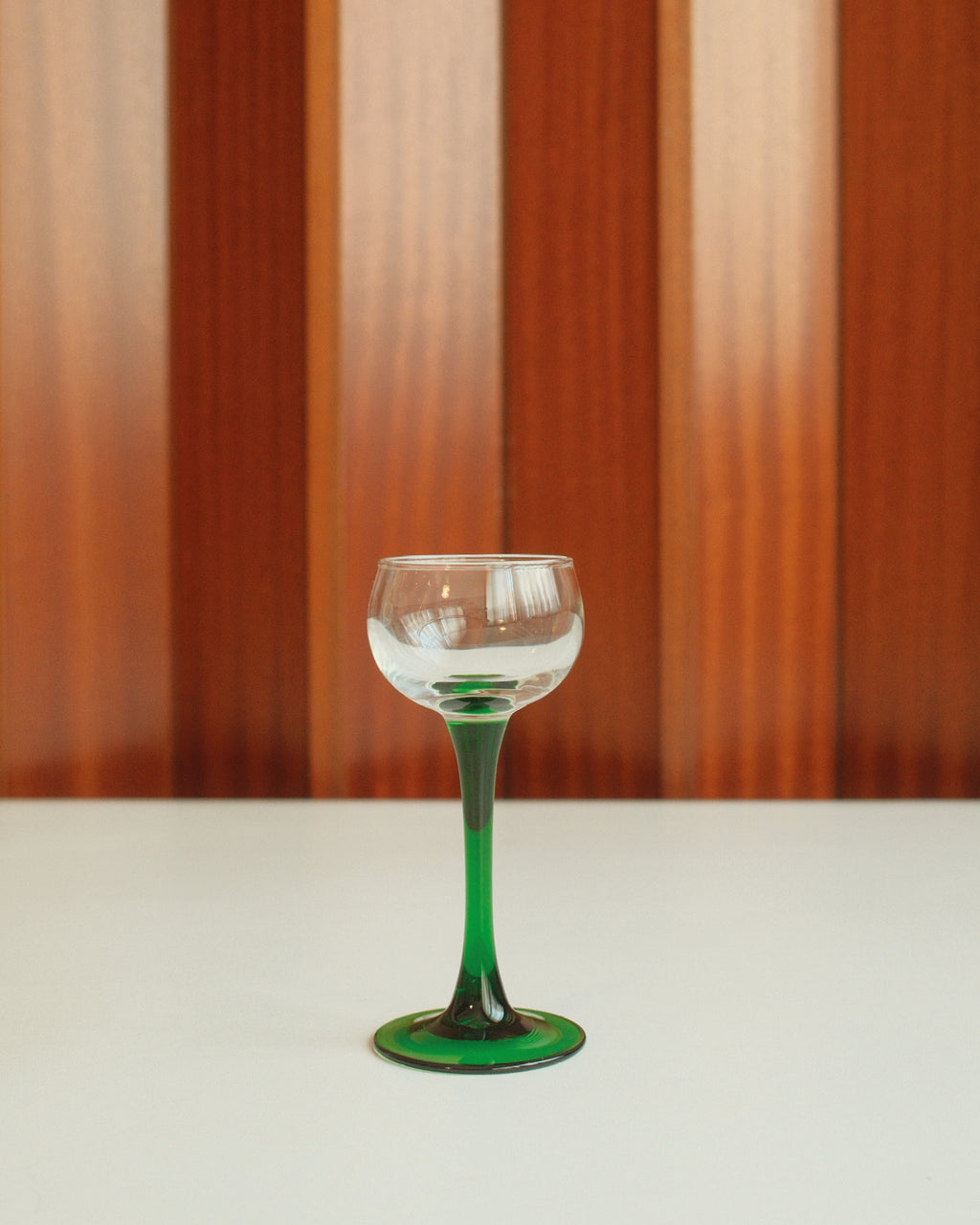 Four glasses with green stems